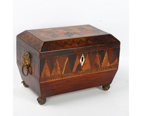 A Regency marquetry inlaid tumbling cube tea caddy, with brass figural ring handles and bun feet, width 20cm, height 14cm, de