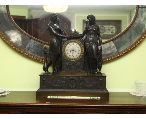 A 19th century French patinated bronze-cased 8-day mantel clock, surmounted by Classical temple figures, engraved silvered di