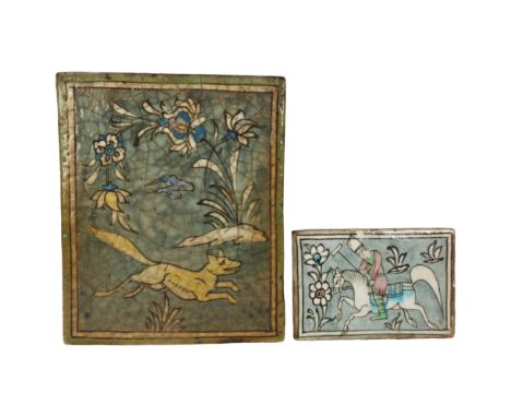 A large Islamic pottery tile with painted running fox design, 31 x 26cm, and an Islamic tile depicting Polo player, 13 x 19cm