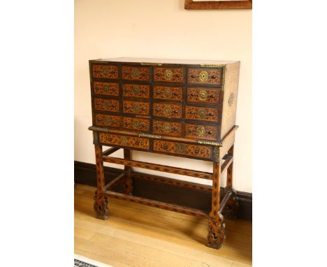 An Indo-Portuguese cabinet on stand (Contador), late 17th century, possibly Old Goa, brass-bound exotic hardwood seaweed marq