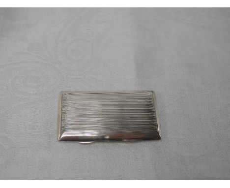 A silver card case of rectangular form having spring hinge, engine turned stripe decoration and gilt lining, London 1920, Sam