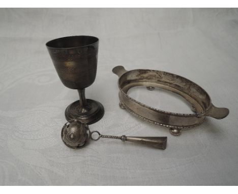 An HM silver stand of small oval form, a French silver egg cup having engine turned decoration and plain cartouche and a whit