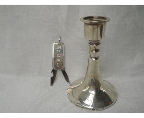 A silver candle stick having a weighted circular splayed base, Birmingham 1933, makers mark worn, and a silver pen knife/bott