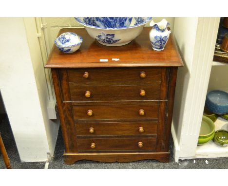 A Victorian mahogany commode, hinged cover enclosing pine interior, five blind drawers, shaped bracket feet