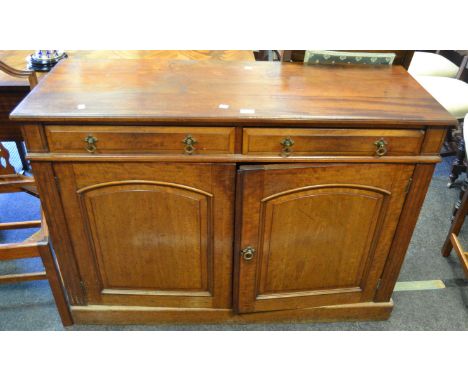 An early 20th century mahogany dresser base, two long drawers to frieze above two arched panel doors enclosing further shelvi