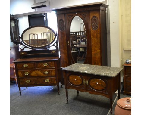 An early 20th century mahogany and burr walnut bedroom suite comprising single wardrobe, central oval mirrored door, scrollin