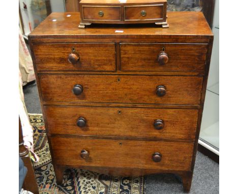 An early Victorian mahogany chest of two short above three long drawers, turned handles, bracket feet