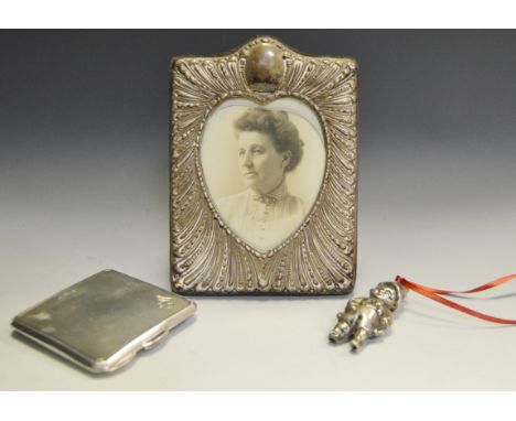 A square silver compact, Birmingham 1938; a child's silver rattle Birmingham 1965, a silver frame, Sheffield 1988 (3)