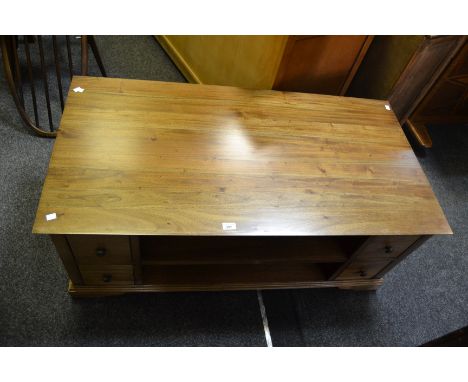 A contemporary mahogany coffee table, two central shelves with 8 short drawers, bracket feet