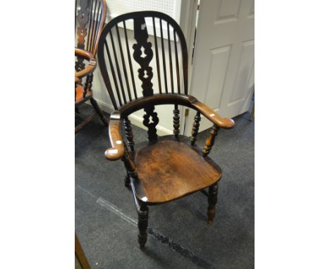 A 19th Century elm bow back Windsor armchair, pierced splat, double refectory stretcher, turned legs