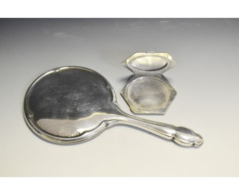 A silver octagonal compact, engine turned, Chester 1941; a silver backed hand mirror , Birmingham 1922 (2)