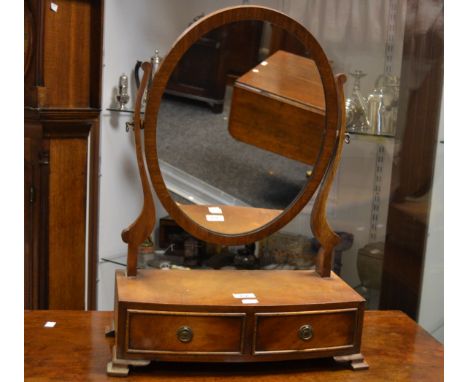 A George III style mahogany oval mantel mirror, two short cock beaded drawers to frieze, bracket feet 
