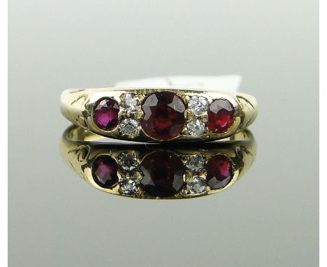 18ct gold 3 stone ruby ring with 4 small diamonds, 
size N.