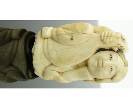 A 19th century Japanese carved ivory netsuke
depicting a musician, height 2".