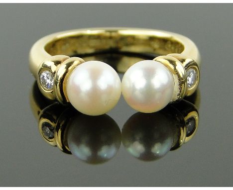 A modern Garrard's 18ct gold pearl and diamond set ring,
pearls 6mm across, size K, 5.8 gm, boxed.