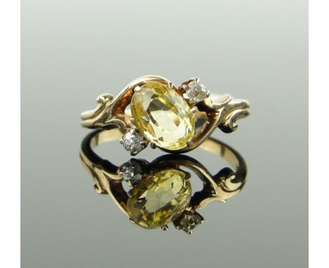 Unmarked gold yellow sapphire ring,
with diamond set shoulders, size K.