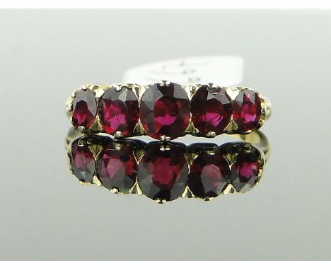 A 5 stone ruby ring,
total content approx. 1.57cts, unmarked gold settings, size M.