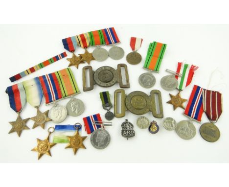 3 sets of Second World War medals including Atlantic Stars,
a belt buckle, silver A R P badge, and other Second World War med