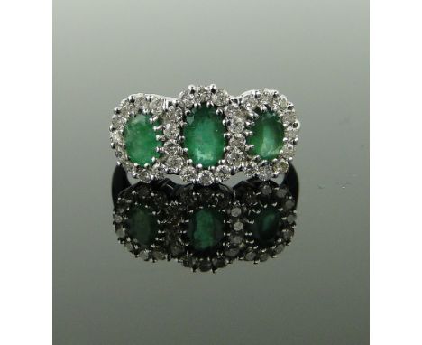 18ct white gold emerald and diamond triple cluster ring,
size K.