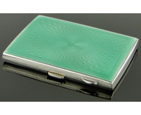 A silver and green enamel cigarette case,
Birmingham 1930, height 8cm.