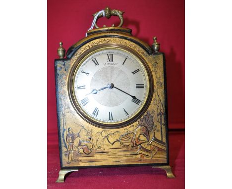 A black lacquered and chinoiserie decorated 8-day mantel clock,
the dial signed J E Beale Ltd., Bournemouth, raised on brass 