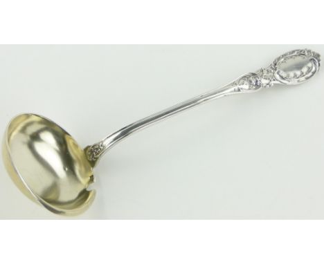 A French silver sauce ladle circa 1900, 
with floral embossed handle, indistinct continental marks, length 23cm.