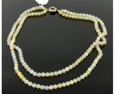 A double string of polished opal beads.