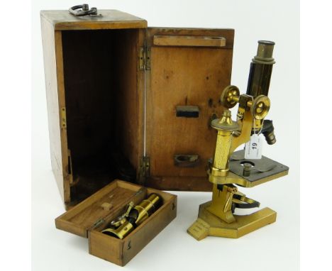 A brass microscope by R & J Beck, London,
12.25", with mahogany case and a cased Victorian brass field microscope.