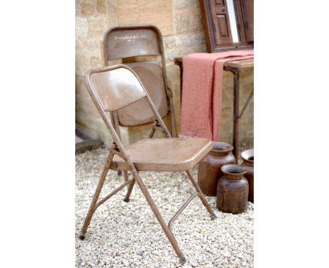 A traditional folding Indian single seater chair cast from treated iron with a brown coating  Perfect for long-lasting outdoo