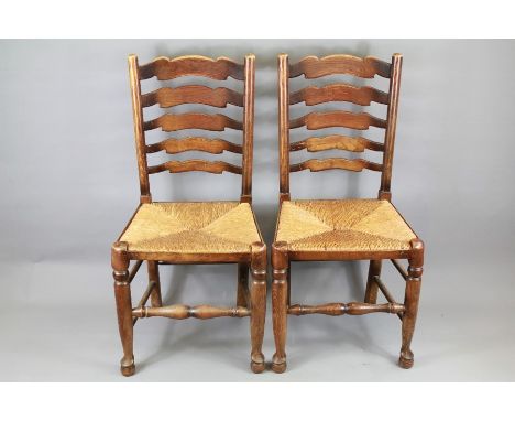Four Ladder-back Dining Room Chairs. The chairs having rush seats turned front legs and stretcher, bun feet. .&nbsp;