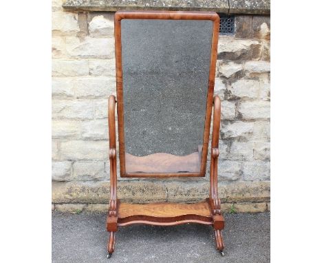 A Late Victorian Cheval Mirror. The bevelled mirror on sturdy stand with swept supports on porcelain casters, approx 82 x 162