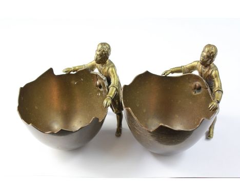 A Pair of 19th Century Brass Table Condiments. The condiments depicting figures holding a coconut shell, approx 9 cms h.