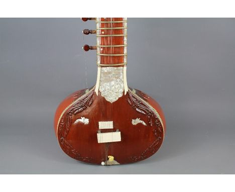 20th Century North Indian Sitar - the string and gourd instrument inlaid with ivory, bone and mother of pearl.&nbsp;