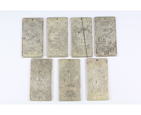 Seven Chinese Silver-Metal Scroll Weights, embossed decoration depicting the Chinese horoscope and the animals of the Zodiac.