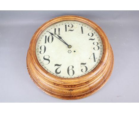 An Oak Frame Circular American Wall Clock. The clock having an enamel face with numeric dial, made by The New Haven Clock Com