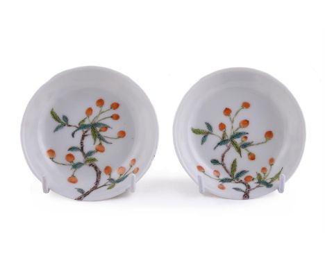 A pair of Chinese famille verte saucers, Tongzhi, painted with fruiting branches on the exterior and extending to the interio
