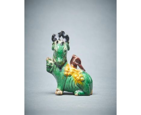 A Chinese small biscuit glazed model of a deer, Kangxi, with front paw raised, 8.5cm high Provenance: Anthony Gustav de Roths