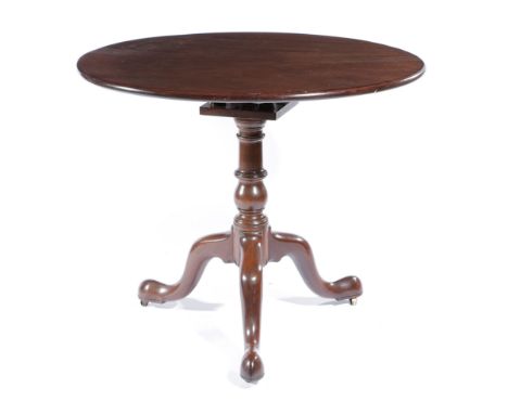 A GEORGE II MAHOGANY TRIPOD TABLE C.1750-1760 the circular revolving tilt-top on a birdcage and on brass castors 74cm high, 8
