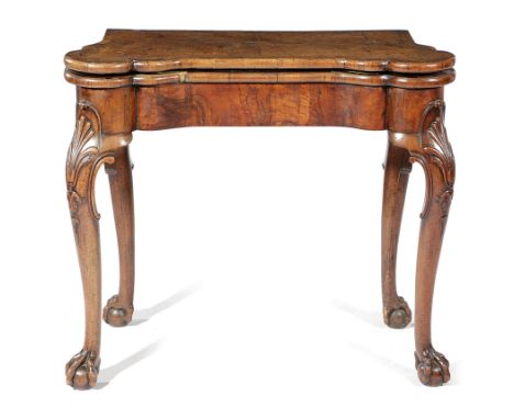 A GEORGE II WALNUT CONCERTINA ACTION CARD TABLE IN THE MANNER OF BENJAMIN CROOK, C.1735 the quarter veneered cross and feathe