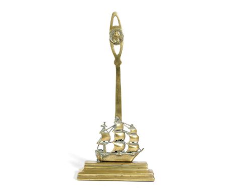 NELSON INTEREST. A VICTORIAN BRASS DOORSTOP IN THE FORM OF H.M.S. VICTORY LATE 19TH CENTURY the pierced handle with a portrai