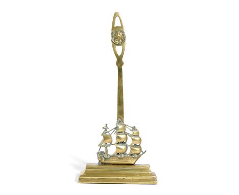 NELSON INTEREST. A VICTORIAN BRASS DOORSTOP IN THE FORM OF H.M.S. VICTORY LATE 19TH CENTURY the pierced handle with a portrai