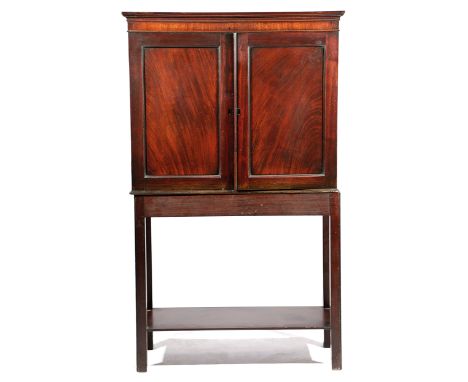 A MAHOGANY CABINET ON STAND 18TH CENTURY ELEMENTS with a pair of panelled doors, enclosing a shelf 127.5cm high, 76.7cm wide,