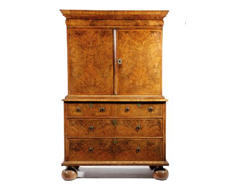 A WILLIAM AND MARY WALNUT CABINET ON CHEST C.1690-1700 cross and feather banded with burr veneers, the cushion frieze drawer 