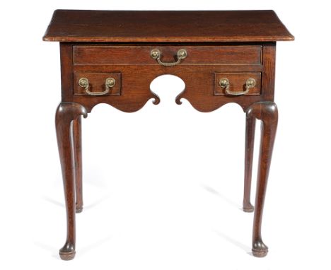 A GEORGE II OAK LOWBOY C.1740 the top with a caddy moulded edge, above three frieze drawers and a shaped apron 76.8cm high, 8