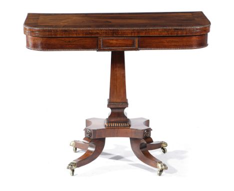 λ A GEORGE IV ROSEWOOD CARD TABLE C.1820 with nulled mouldings, the hinged swivel top with a baize lined playing surface, on 