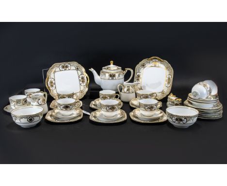 A Noritake Teaset circa 1920's. Design no No 44318. Golden Basket Pattern. Comprises teapot, 2 milk jugs, 2 sugar bowls, a cr