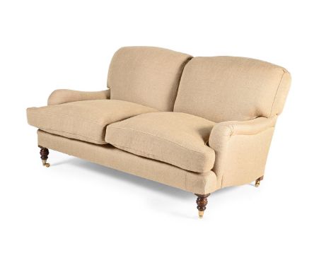 A BEECH AND UPHOLSTERED TWO SEAT SOFA IN THE MANNER OF HOWARD AND SONS, OF RECENT MANUFACTURE 77cm high, 148cm wide, 84cm dee