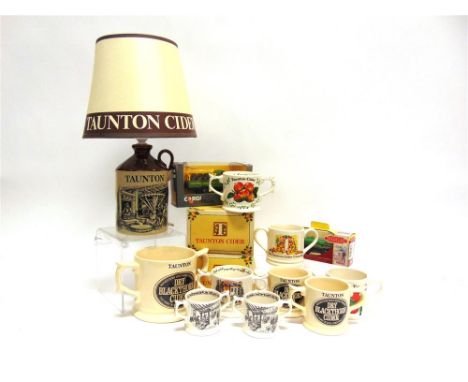 TAUNTON CIDER Eleven twin-handled cider mugs, including some limited editions, two of them boxed; together with a table lamp 