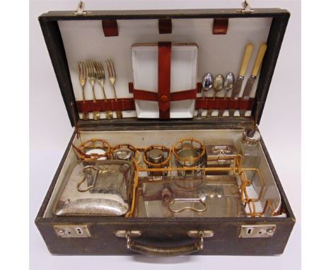 AUTOMOBILIA - A PICNIC SET circa 1920s-30s, the various plated metal and ceramic contents retained in wicker holders, overall