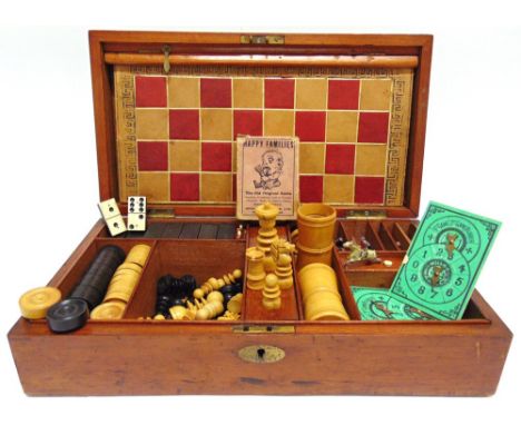 A GAMES COMPENDIUM late 19th or early 20th century, comprising a set of chess pieces (one replaced), dominoes, draughts, play